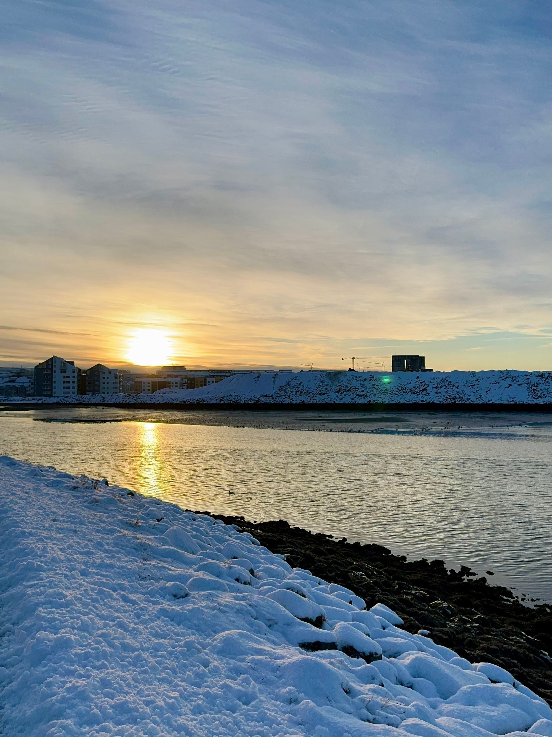 A view of the ocean outside of Grafarvogur bay. You can see the docks and docksiden neighbourhoods across the water.