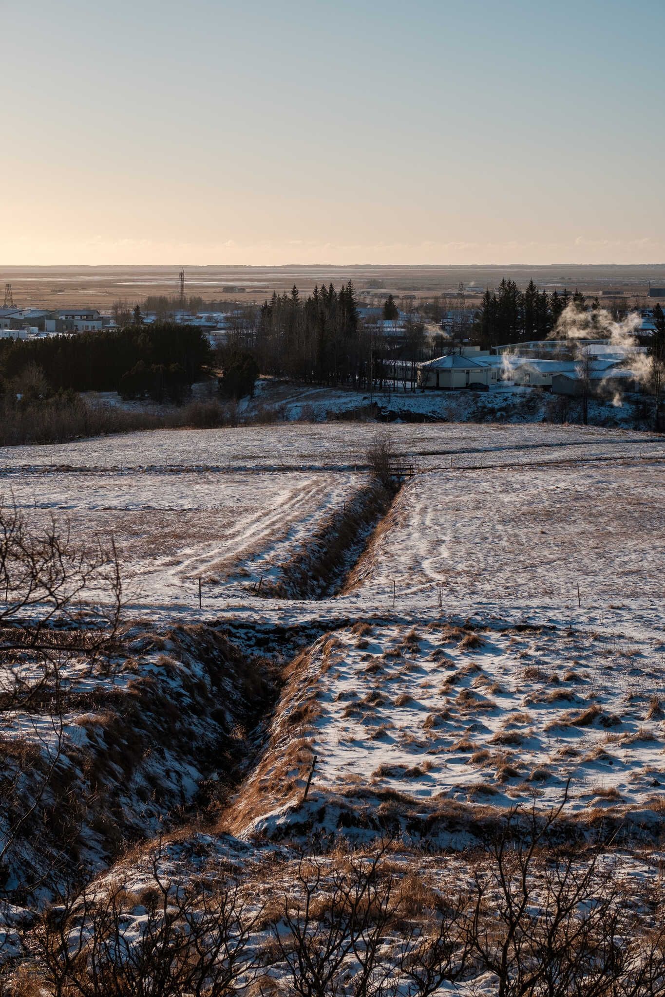 A field with ditches cut into it. The snow that covers it makes everything feel a little bit more geometric