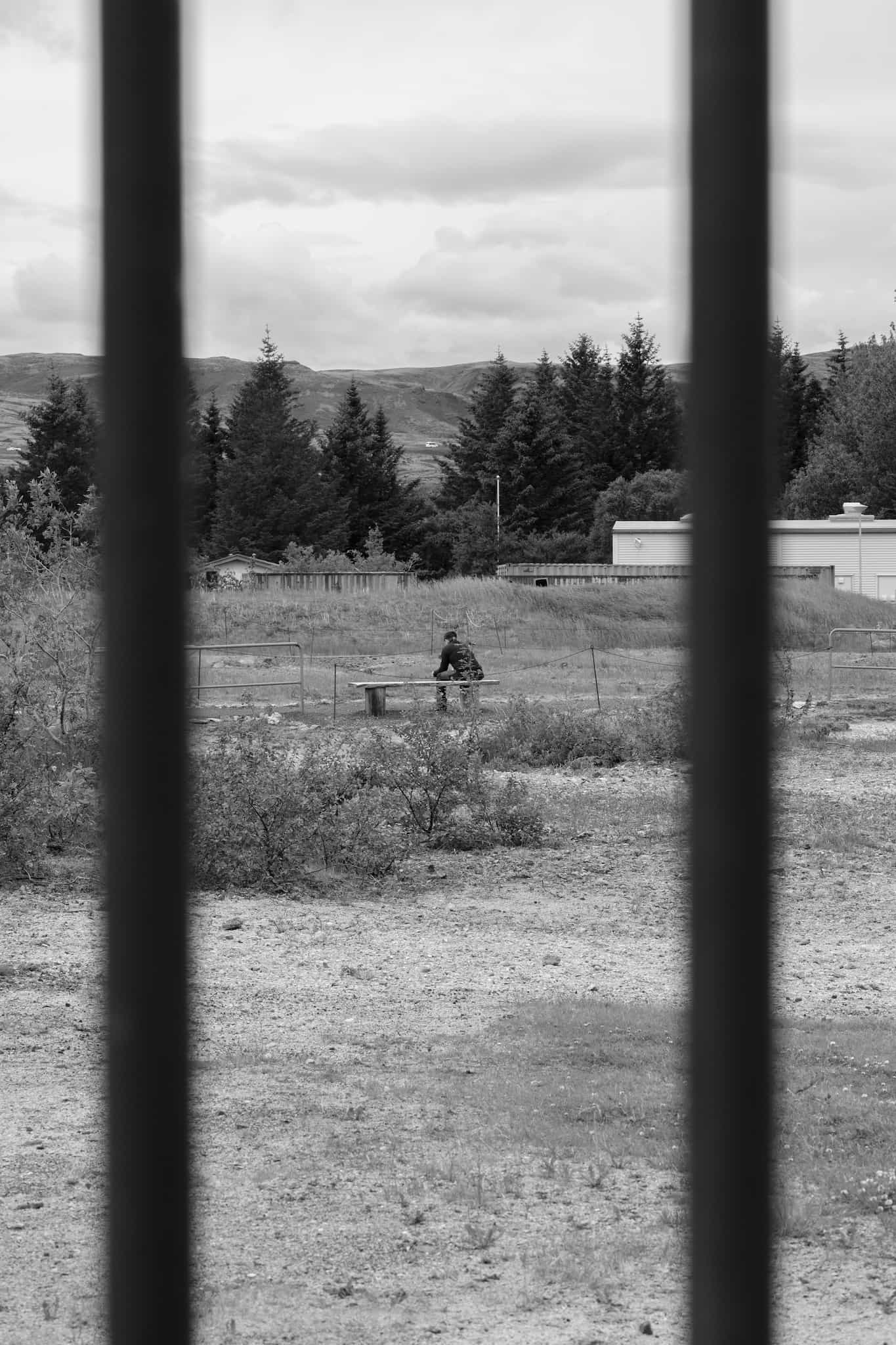 A tourist rests on a bench in the geothermal park.