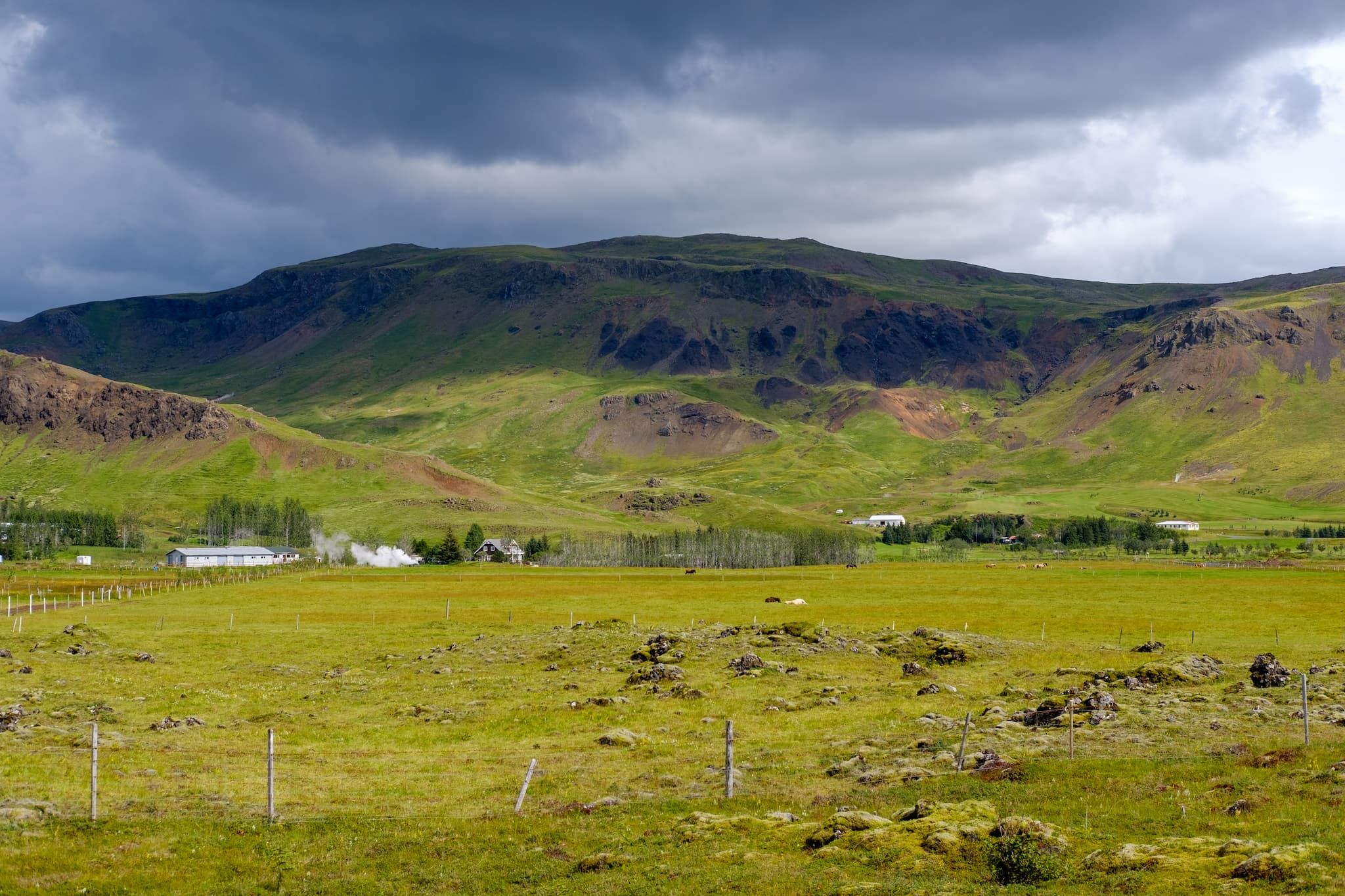 A view of the stables at the root of a mountain.